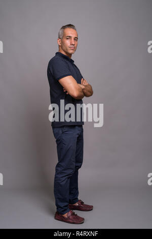 Full length profile view shot of handsome Persian man with gray hair Stock Photo