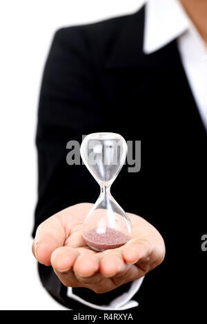 Business woman holding hourglass against white Stock Photo
