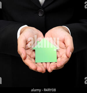 House shape in business woman's hands Stock Photo