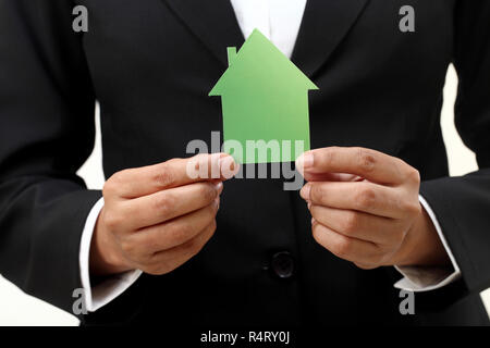 Business woman hands holding house shape Stock Photo
