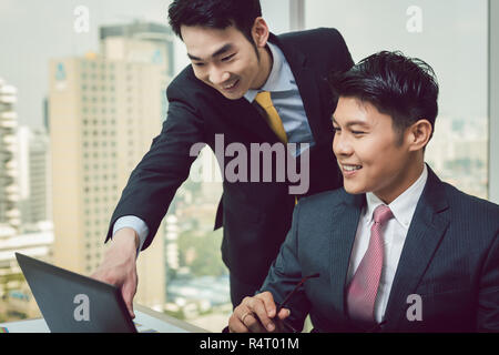 Two businessman discussing on laptop Stock Photo