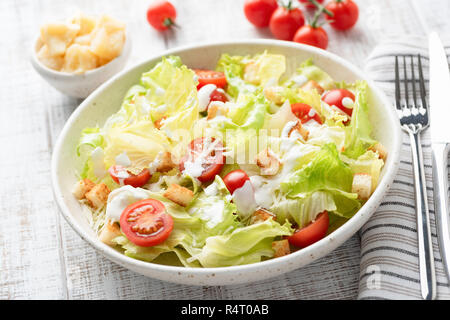 Caesar salad on a plate, closeup view. Meatless caesar salad with croutons and sauce Stock Photo