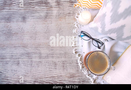 Composition with book, glasses and cotton pillows on wooden background Stock Photo