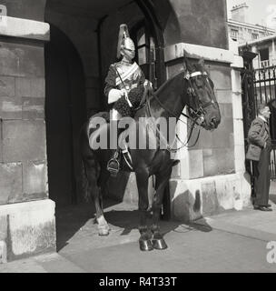 1960s, historical, a mounted member of the Household Cavalry, the Queen's Life Guard, standing outside Horse Guards, the official entrance to St James and Buckingham Palace since 1660. Stock Photo