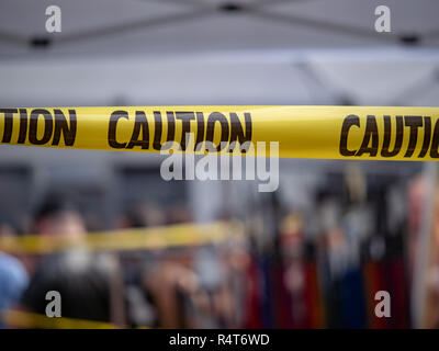Yellow caution tape, do not enter area, hanging blocking area Stock Photo