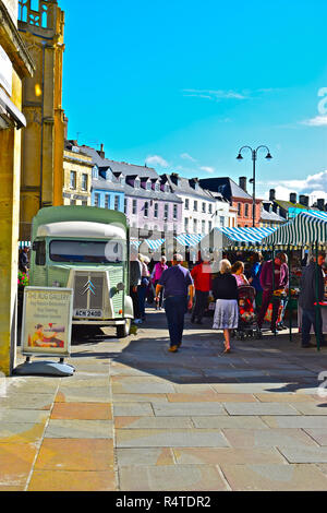 Cirencester Market Place on a busy Saturday. The old French Citroen HY van is converted to use as a coffee stall and adds character to this scene, Stock Photo