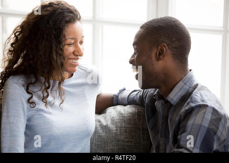 Smiling African American couple in love sitting together Stock Photo