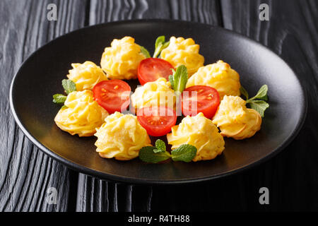 Delicate tasty Duchess Potatoes closeup on a black plate on a wooden table. horizontal Stock Photo