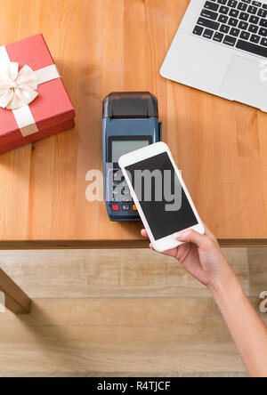 Pay with cellphone on POS machine for present Stock Photo