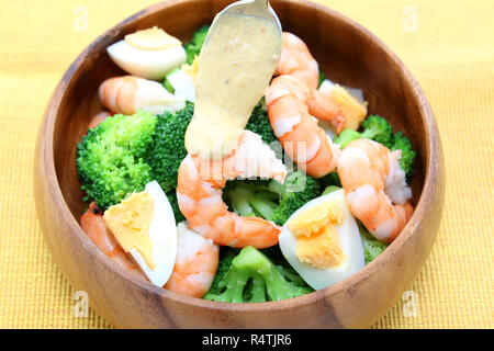 Wooden bowl of boiled peeled shrimp, cauliflawer and egg Stock Photo