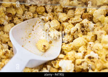 fresh sweet popcorn and shovel in a popcorn machine, close up with selected focus, and narrow depth of field Stock Photo