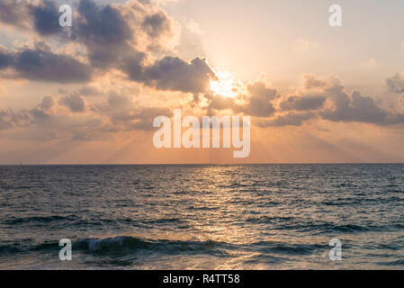 Sunset over the sea, clouds with sunrays, Tel Aviv, Israel Stock Photo