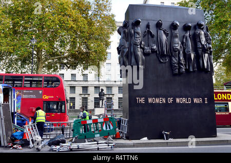 Men at work in Whitehall constructing barriers for the annual Remembrance Day parade, London, England, UK. Stock Photo