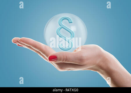 Female hand holding 3d paragraph symbol. Concept for justice. Stock Photo