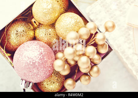Merry Christmas and happy New year. Golden Christmas toys on a light background. Christmas background. Stock Photo