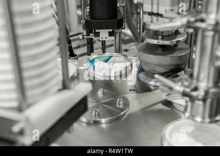 production and bottling of yogurt in plastic cups. equipment at the dairy plant Stock Photo