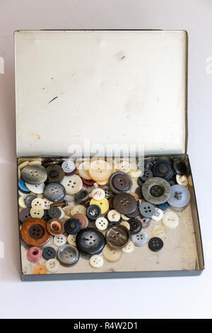 A close up view of a old metal box with differnt size and colour buttons on a isolated white background Stock Photo