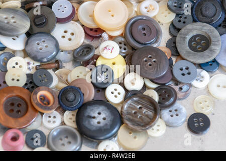 A close up view of a old metal box with differnt size and colour buttons on a isolated white background Stock Photo