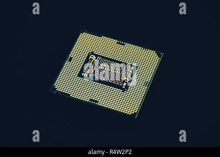 Electronic collection - CPU from the bottom side isolated on black background. Stock Photo