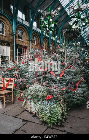 London, UK - November 21, 2018: Christmas trees and decorations in Covent Garden Market, one of the most popular tourist sites in London, UK. Stock Photo