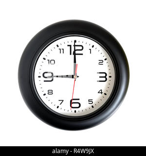 Big round wall clock with a black rim isolated on white background close-up and arrows showing nine o'clock Stock Photo
