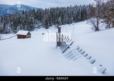 wooden house in a perfect snowy winter landscape. Snow covered rural ...