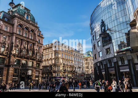 Vienna, Austria - December 24, 2017. Stephansplatz square at city centre of Vienna by sunny winter day. Facades of historic buildings and people walki Stock Photo