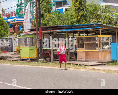 Kaimana, Indonesia - January 31, 2018: A group of Indonesian, children in blue and red uniform walking on the street in the small village on the West  Stock Photo