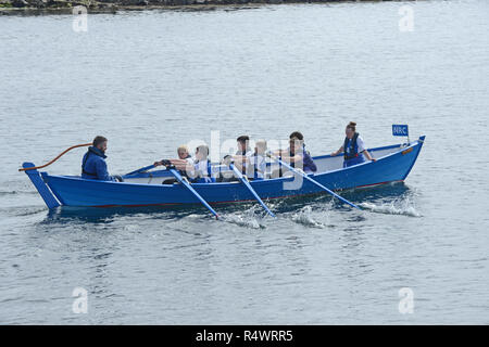Shetland rowing regatta being held in Hamnavoe Burra in the Shetland Islands during the summer. Local teams race for each district