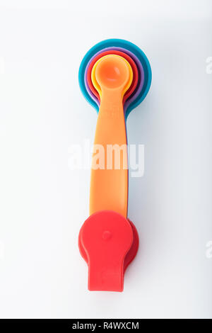 Kitchen: Top View of Multi Colored Measuring Spoons Isolated on White Background Shot in Studio Stock Photo