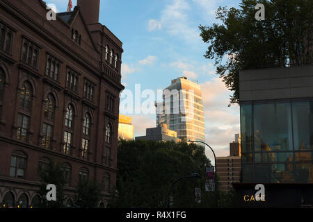 Looking South from Cooper Square in New York City to a person standing on a deck at the Standard Hotel in the East Village. Stock Photo