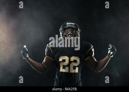 African American football player isolated on black. Stock Photo