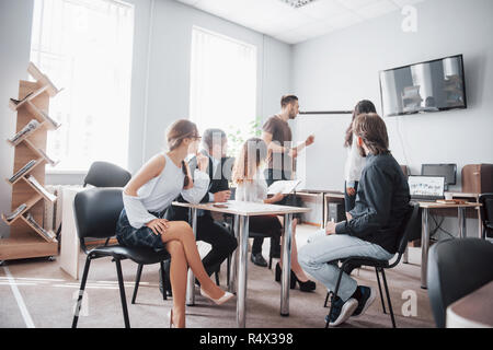 Group of young business people working and communicating together in creative office Stock Photo