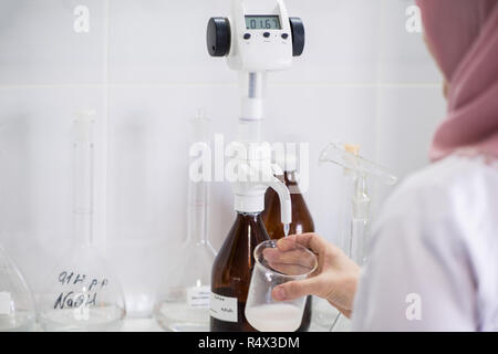 woman testing samples of dairy products in the laboratory. test laboratory of a milk factory Stock Photo