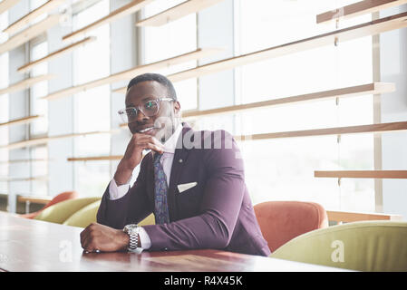 A beautiful young African American who thinks about a serious idea. Confident in making business decisions Stock Photo