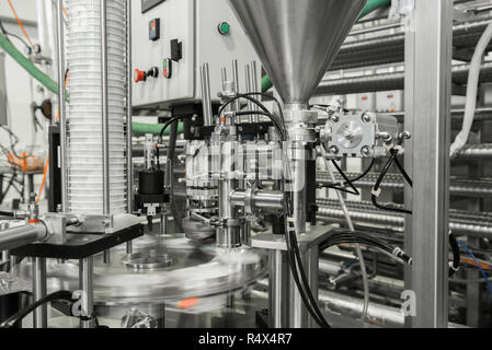 production and bottling of yogurt in plastic cups. equipment at the dairy plant Stock Photo