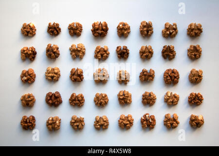 Walnut halved kernels pattern isolated on white background from a high angle view Stock Photo