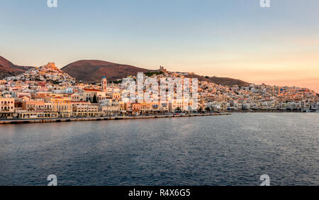 Panorama view of the picturesque townscape of Ermoupoli with port, churches and the chora Ano Syros on the hill at first light, Greek island Syros, Cy Stock Photo
