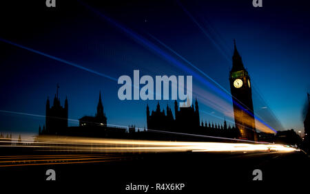 The Palace of Westminster and Big Ben in central London at sunset with rush hour traffic streaking by Stock Photo