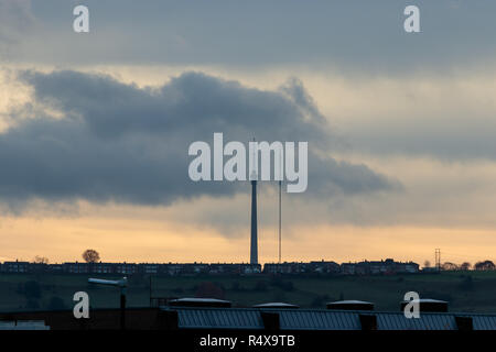 Emley Moor TV broadcast mast, and it's temporary replacement, as seen from Dewsbury town centre Stock Photo