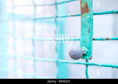 fence and the wicket of the welded wire mesh green color with black round handle Stock Photo