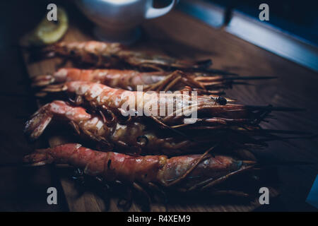 fried until golden brown tiger shrimp are ready in a pan and serving at the table. Stock Photo