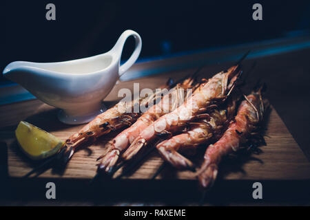 fried until golden brown tiger shrimp are ready in a pan and serving at the table. Stock Photo