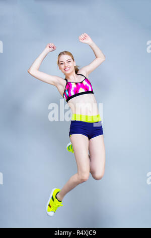 Young woman practices fitness exercises Stock Photo