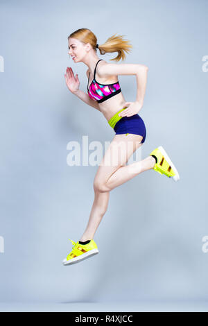 Young woman practices fitness exercises Stock Photo