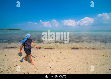 A tourist explores Santa Carolina Island, Bazaruto archipelago Mozambique. Stock Photo