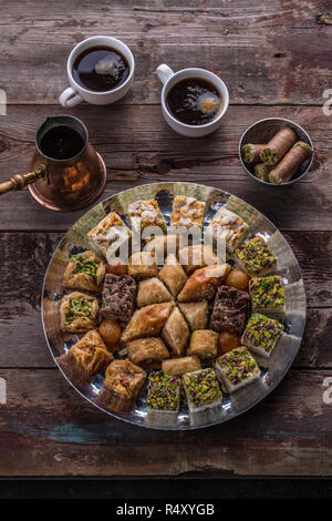 Arabian sweets and delights with coffee on rustic table Stock Photo