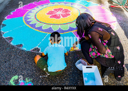 Traditional Rangoli floor mandal decoration made from coloured rice, India Live Street Festival and Celebration, Granville St. Vancouver, British Colu Stock Photo