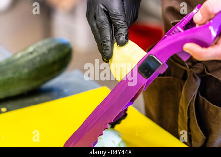 Male Chef Cutting Eggplant in the Kitchen - with Glove on his Hand Stock Photo