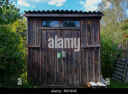 Old wooden accessory dwelling unit on a summer house lot Stock Photo